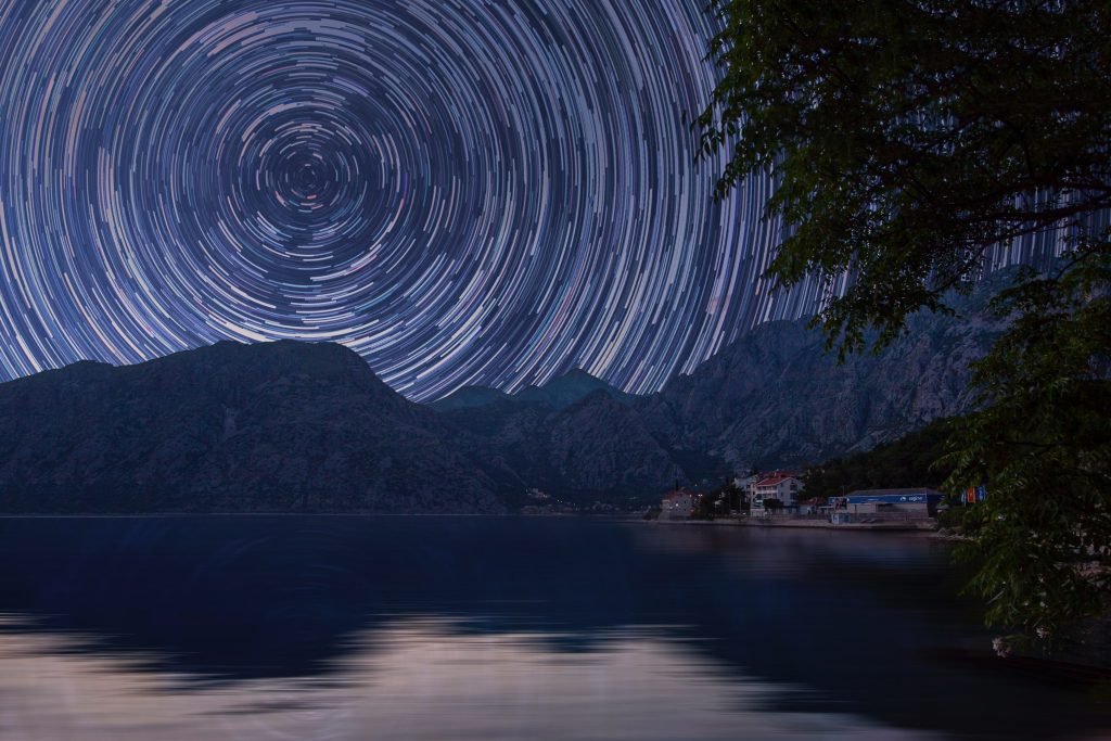 photo of star trails over mountains