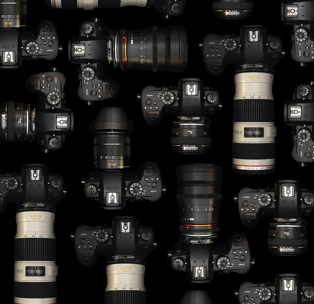 Assortment of professional DSLR cameras and lenses on a black background, showcasing different models and photography equipment for various shooting conditions